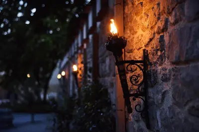 a light on the side of a brick wall at Hotel Grad Otočec - Relais Chateaux in Otočec