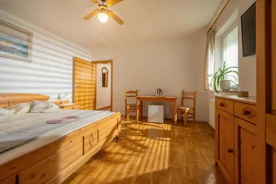 a bedroom with a bed and a table with chairs at Rooms & Apartments Pr Matjon in Bled