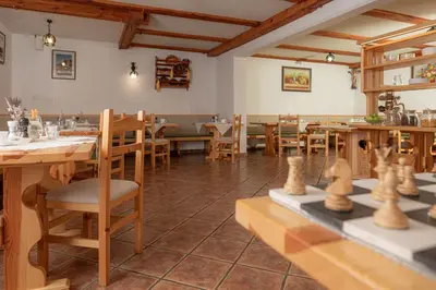 a restaurant with wooden tables and chairs in a room at Rooms & Apartments Pr Matjon in Bled