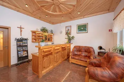 a living room with leather chairs and a wooden ceiling at Rooms & Apartments Pr Matjon in Bled