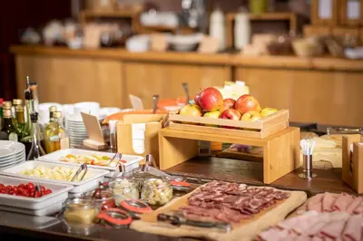 a table with a buffet of food on it at Bohinj Eco Hotel in Bohinj