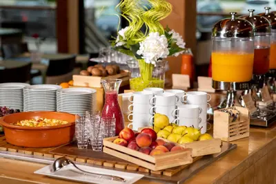 a buffet with fruit and drinks on a table at Bohinj Eco Hotel in Bohinj