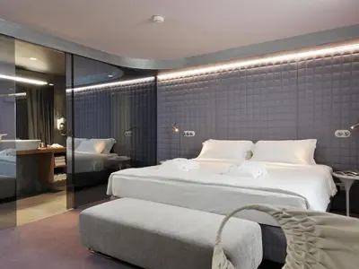 a hotel room with two beds and a bathroom at Vander Urbani Resort - a Member of Design Hotels in Ljubljana