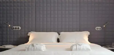 a bedroom with a large white bed with white pillows at Vander Urbani Resort - a Member of Design Hotels in Ljubljana