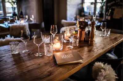 a wooden table with wine glasses and candles on it at Vander Urbani Resort - a Member of Design Hotels in Ljubljana