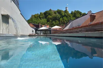 a swimming pool with blue water in a building at Vander Urbani Resort - a Member of Design Hotels in Ljubljana
