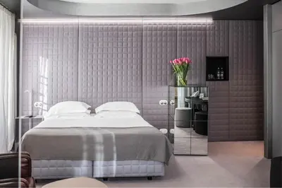 a bedroom with a bed and a vase of flowers at Vander Urbani Resort - a Member of Design Hotels in Ljubljana