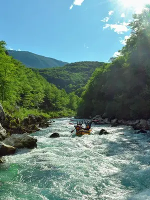 a group of people in a raft in a river at Apartments Skok with rafting and free parking in Bovec