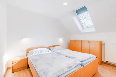 a bedroom with a bed and a window at Apartments Skok with rafting and free parking in Bovec