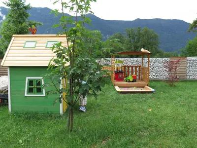 a backyard with a play house and a gazebo at Apartments Skok with rafting and free parking in Bovec