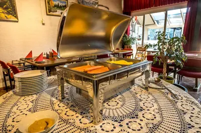 a grill sitting on a table with carrots in it at Hotel Center Bohinjsko Jezero in Bohinj