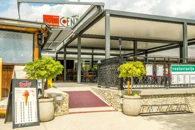 a store front with potted trees in front of it at Hotel Center Bohinjsko Jezero in Bohinj