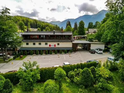 an aerial view of a building with a parking lot at Hotel Center Bohinjsko Jezero in Bohinj
