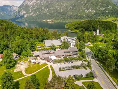 an aerial view of a building next to a lake at Hotel Center Bohinjsko Jezero in Bohinj