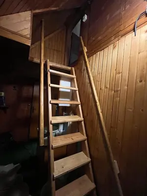 a wooden staircase in a room with wooden walls at Chalet Kanja Velika Planina in Stahovica