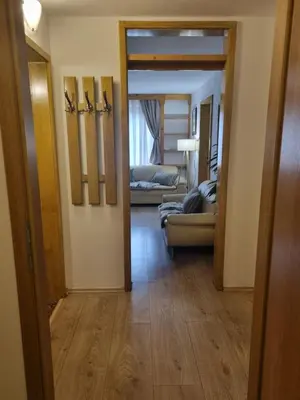 a hallway with a living room with a couch at Art Hotel Kristal in Bohinj