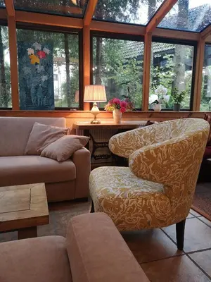 a living room with a couch and a chair at Art Hotel Kristal in Bohinj