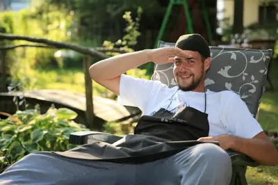 a man sitting in a chair with his hand on his head at Art Hotel Kristal in Bohinj