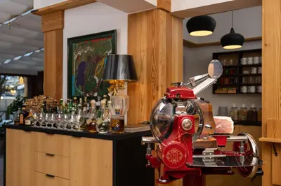 a bar with a red machine at a counter at Hotel Lipa in Kranjska Gora