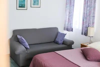a living room with a couch and a bed at Vila Romana in Kranjska Gora