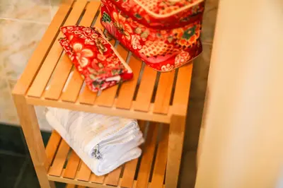 a wooden shelf with towels on top of a table at Vila Romana in Kranjska Gora