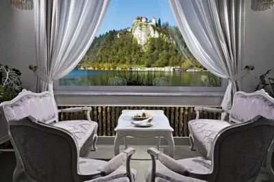 a room with a large window with a table and chairs at Grand Hotel Toplice - Small Luxury Hotels of the World in Bled