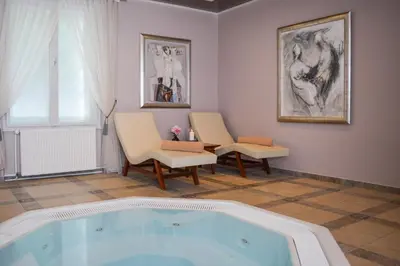 a living room with a hot tub and chairs at Vila Bled in Bled