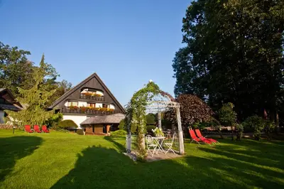 a yard with a playground and a house at Alp Pension in Bled