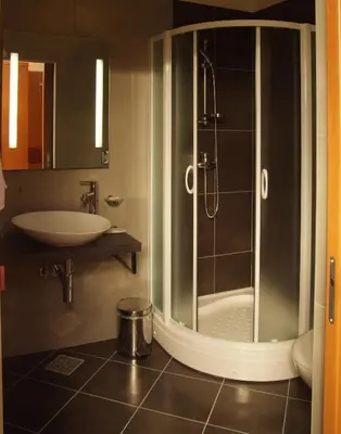 a bathroom with a shower and a sink at Hotel Vila Emei in Maribor