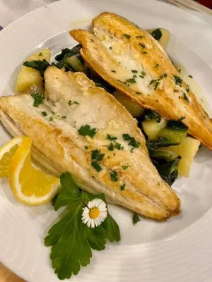 a plate of food with fish and vegetables on it at Gostisce Golob in Zgornja Polskava