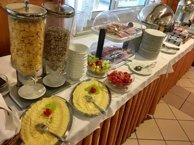 a buffet with plates of food on a table at Gostisce Golob in Zgornja Polskava