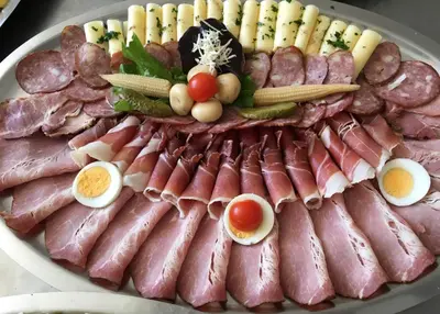 a platter of meats and eggs on a plate at Gostisce Golob in Zgornja Polskava