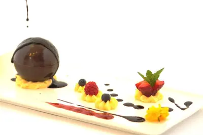 a plate of food with chocolate and fruit on it at Hotel Leonardo in Slovenska Bistrica