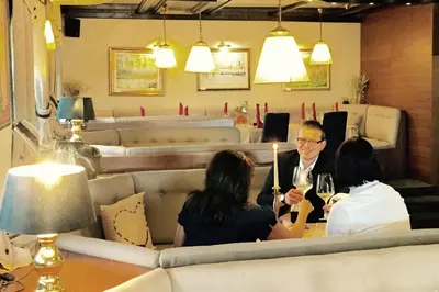three people sitting at a table in a restaurant at Hotel Leonardo in Slovenska Bistrica