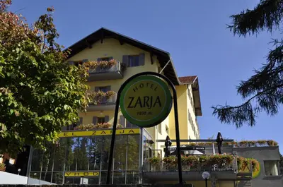 a clock in front of a building at Hotel Zarja in Pohorje