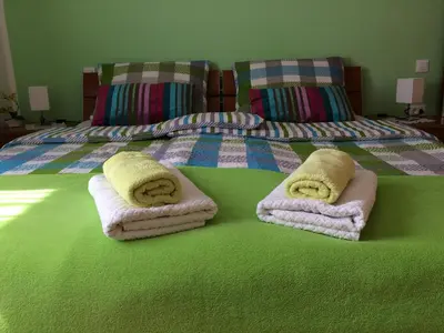 a bedroom with a bed with towels on it at Apartments and Rooms Tavcar in Bled