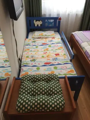 a small bedroom with two beds and a tv at Apartments and Rooms Tavcar in Bled