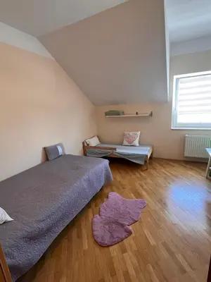 a bedroom with a bed and a rug on the floor at Peaceful 4-room house in Maribor - ski friendly in Maribor