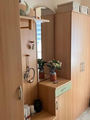 a kitchen with wooden cabinets and flowers in jars at Peaceful 4-room house in Maribor - ski friendly in Maribor