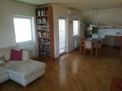 a living room with a couch and a table at Peaceful 4-room house in Maribor - ski friendly in Maribor