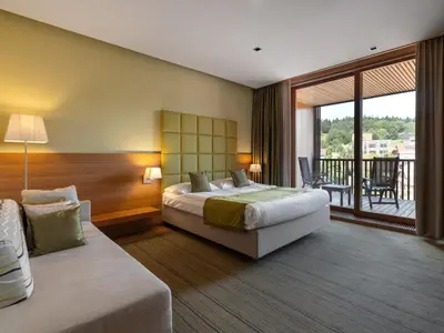 a hotel room with a bed and a balcony at Hotel Balnea Superior - Terme Krka in Dolenjske Toplice