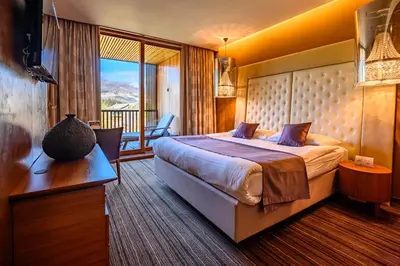a hotel room with a bed and a balcony at Hotel Balnea Superior - Terme Krka in Dolenjske Toplice