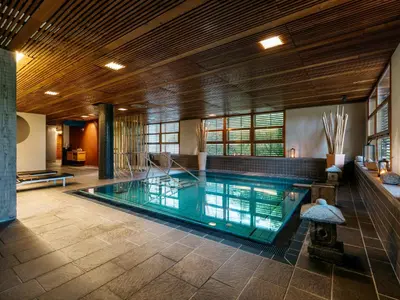 a swimming pool in a large room with a large ceiling at Hotel Balnea Superior - Terme Krka in Dolenjske Toplice