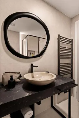 a bathroom with a sink and a mirror at Harmonija Padel&Wellness Resort in Mengeš