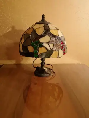 a glass lamp sitting on top of a wooden floor at Domačija Linč in Rodik