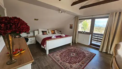 a bedroom with a bed and a large window at Apartment Panorama & Bella Vista in Bohinjska Bela
