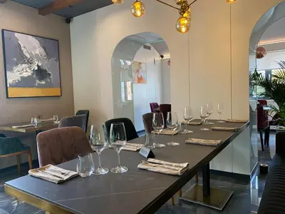 a table in a restaurant with wine glasses on it at Hotel MOREA in Ljubljana