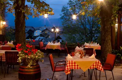 a restaurant with tables and chairs at night at Pension Lectar in Radovljica