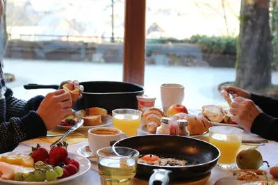 a group of people sitting at a table eating breakfast at Pension Lectar in Radovljica