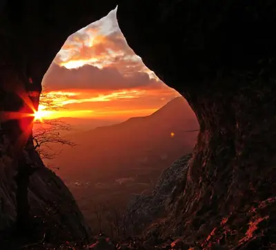 a view of the sunset from a cave at Gostilna Tratnik in Zoll